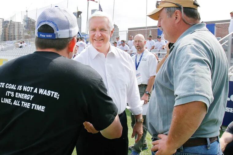 Pennsylvania Governor Tom Corbett, center, visits with attendees at a rally to support American energy and jobs in the coal and related industries at Highmark Stadium in downtown Pittsburgh, Wednesday, July 30, 2014. The rally is being held the day before the Environmental Protection Agency conducts public hearings on its new emissions regulations for existing coal fired power plants. (AP Photo/Gene J. Puskar)
