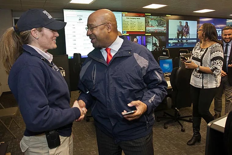 Mayor Nutter and Sam Phillips, head of the city's Office of Emergency Management, at Fire Department headquarters, where she and crew members monitor the storm.