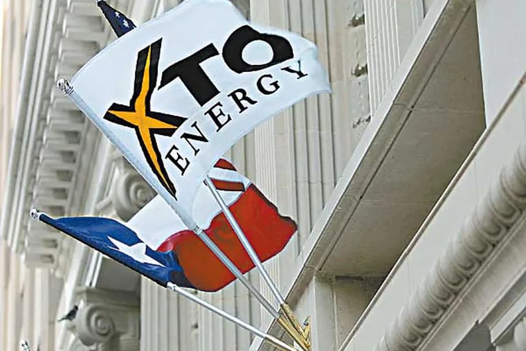FILE - In this Nov. 3, 2005 file photo, an XTO Energy flag adorns the new Bob R. Simpson Building, in Fort Worth Texas. Exxon Mobil will buy XTO Energy in an all-stock deal worth $31 billion as the oil giant moved aggressively Monday, Dec. 14, 2009, to capitalize on the growing supply of natural gas at home. (AP Photo/Fort Worth Star-Telegram, Ron Jenkins, file)