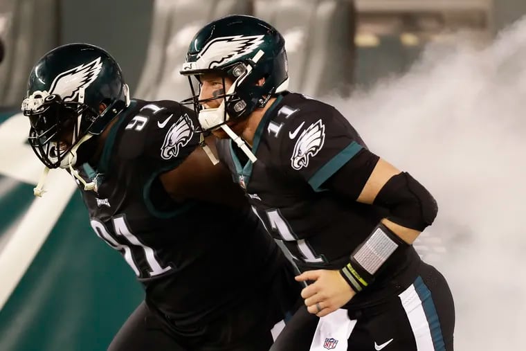 Carson Wentz and the Eagles face the rival Cowboys on Sunday night and aim to remain atop the NFC East standings.