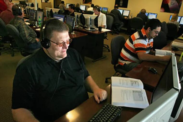 After being laid off in October, John Sparenberg, foreground, decided to earn his certification as a Microsoft-certified systems engineer, as pictured here June 5, in Dallas, Texas. (Melanie Burford / The Dallas Morning News)