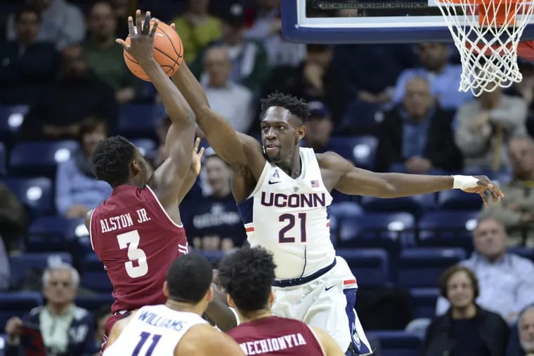 Connecticut's Mamadou Diarra  blocks a shot by Temple's Shizz Alston in the first half.