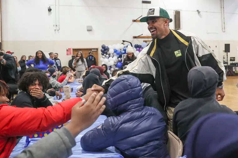 Eagles quarterback Jalen Hurts surprises students during an event to honor Nicolas Elizalde at Walter B. Saul High School in Philadelphia Dec. 13.