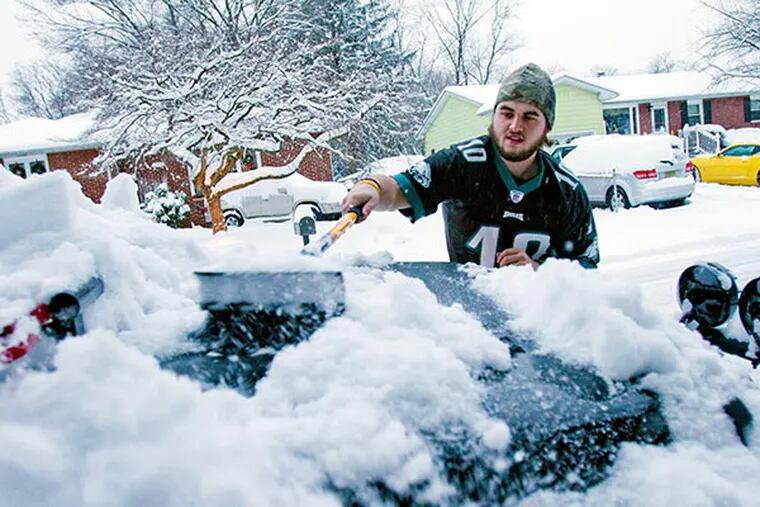 Joe Coffee, of Cherry Hill, waited until after watching the Eagles victory over Detroit before clearing the snowfall from his Jeep on Sunday in Cherry Hill. More snow, up to 6 inches, is expected today.  ( DAVID M WARREN / Staff Photographer )
