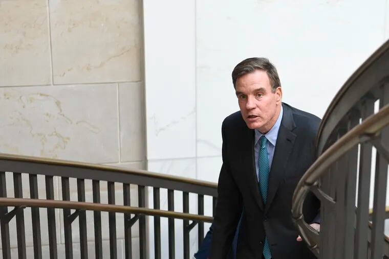 Sen. Mark Warner, D-Va., walks on Capitol Hill in Washington, Wednesday, July 10, 2019, after attending a briefing on election security. (AP Photo/Susan Walsh)