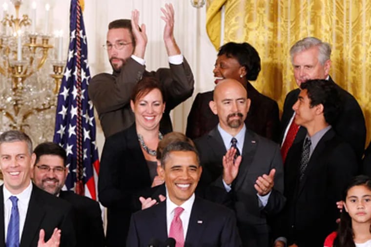 John Becker, a fourth grade teacher from DC Prep Public Charter School in Washington, top row center, reacts after he was acknowledged by President Obama. (AP Photo/Charles Dharapak)