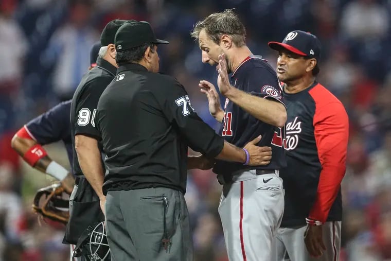 Nationals pitcher Max Scherzer gets checked by umpires during the fourth inning at Citizens Bank Park.