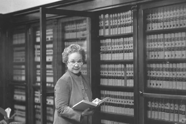 Judge Juanita Kidd Stout at a line of law books in her office. (File Photo)