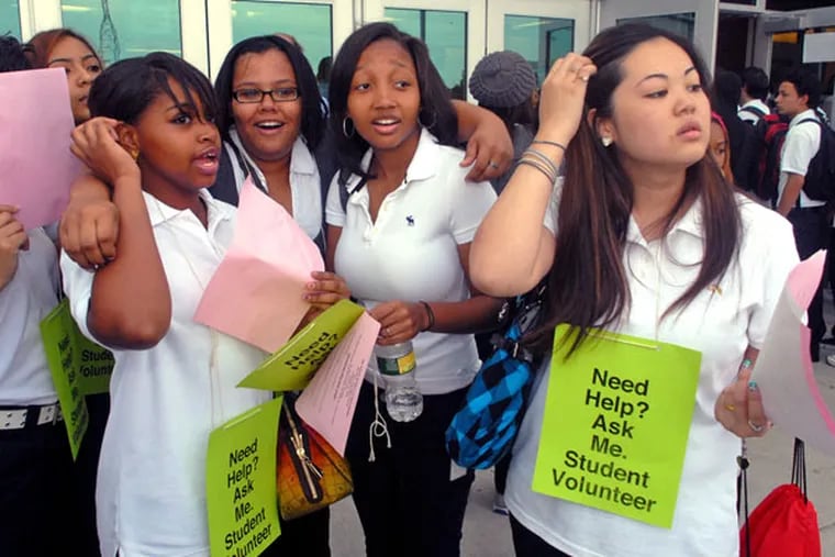 Peer Mediators, left to right, Annmarie Wilson; Shenise Soto and Simone Willis, all juniors, and Claudia Tran, a senior, are on hand outside the new Fels High School to greet classmates as they arrive for the first day of school. The student volunteers had been trained and were there to help anyone with questions.