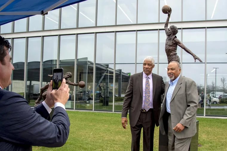 Julius Erving – and his new sculpture – poses with Clint Richardson (right), his Sixers teammate when they won the NBA title in 1983.
