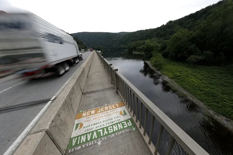 A truck motors passed a marker on the Delaware Water Gap Toll Bridge. The bridge is the connection for hikers on the Appalachian Trail from Pennsylvania and New Jersey.