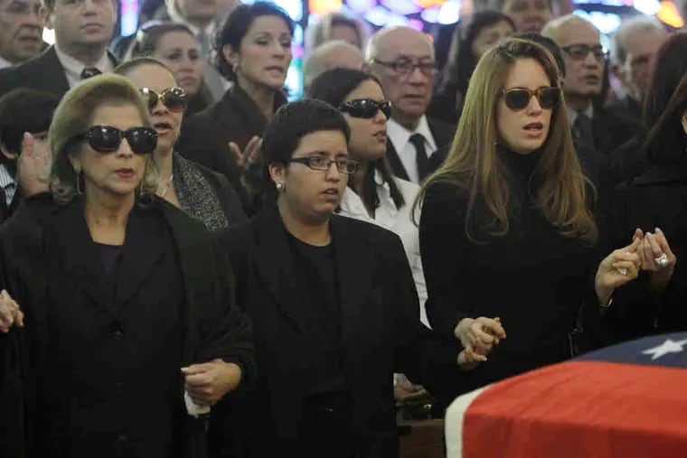 Cecilia Matos (left) joins hands with Cecilia Victoria Perez (center) and Maria Francia Perez, daughters of Carlos Andres Perez, at his Funeral Mass in Miami yesterday.