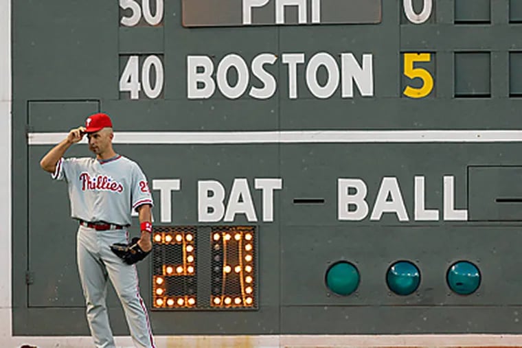 Raul Ibanez adjusts his cap in front of the 'Green Monster'.  (AP Photo/Charles Krupa)