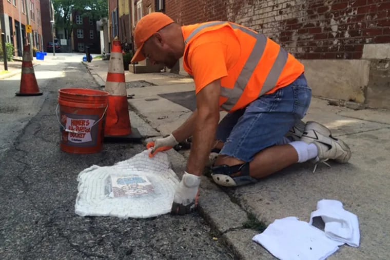 Artist Jim Bachor fills a pothole in Queen Village with an Arctic Splash-inspired mosaic.