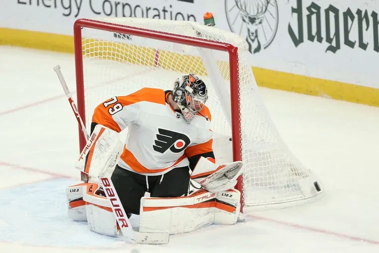 Philadelphia Flyers goaltender Carter Hart (79) watches a shot go wide of the net during the third period of an NHL hockey game against the Buffalo Sabres on Saturday, Jan. 22, 2022, in Buffalo, N.Y. (AP Photo/Joshua Bessex)