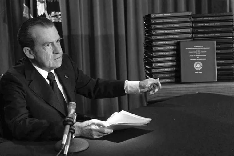 President Richard M. Nixon points to transcripts of White House tapes on April 29, 1974, after announcing that he would turn them over to House impeachment investigators.