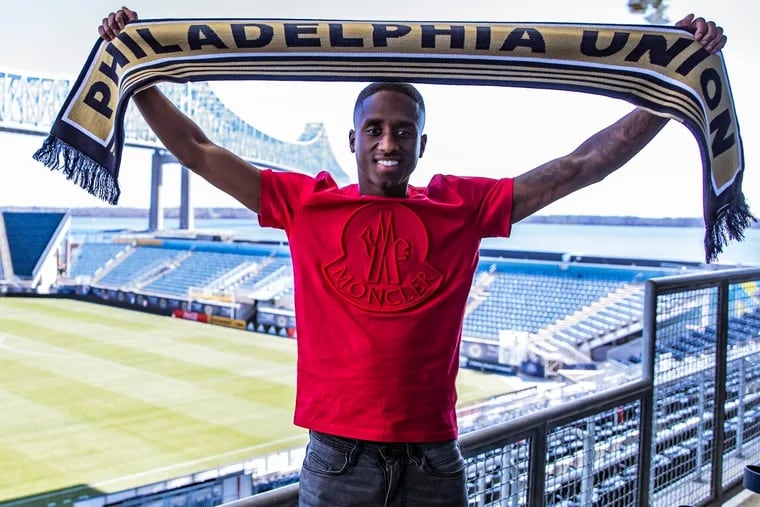 New Philadelphia Union midfielder Jamiro Monteiro holds up a scarf at Talen Energy Stadium after joining the team.