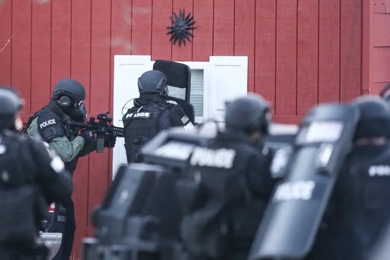 County SWAT units surround the home of Bradley William Stone on December 15, 2014. Stone killed his ex-wife, Nicole Stone, and five of her relatives, sparking a two-day manhunt that ended with his suicide.