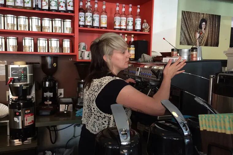 Amy, a barista at Green Line Cafe's location on Locust Street near 44th in West Philly, whips up a coffee. ( Vinny Vella / Daily News Staff)