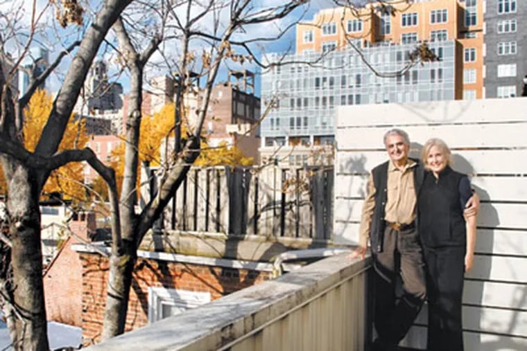 Cecil and Fairley Baker pose on balcony on rear of their South 11th Street home in Washington Square West. (Tom Gralish / Staff Photographer)