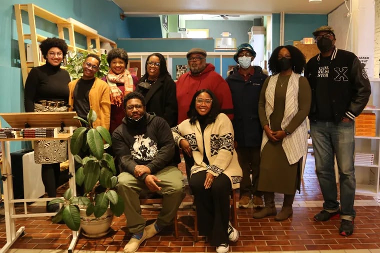 Christopher R. Rogers, (left) and  Fajr Muhammad, the co-editors of "How We Stay Free" are seated in the front row at a Feb. 5 book launch at Making Worlds Bookstore and Social Center in West Philadelphia.  Book contributors  are shown:   (back row, left to right) Malkia Okech, Jared Michael Lowe, Koren Martin, Andrea Lemoins, Duiji Mshinda, Tafari Robertson, Krystal Strong, Gabriel Bryant.