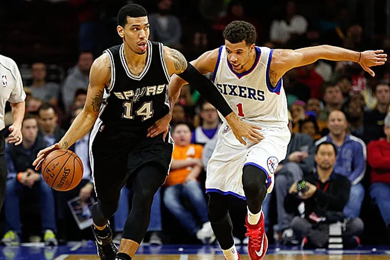 Spurs guard Danny Green and 76ers guard Michael Carter-Williams compete during the second half. (Bill Streicher/USA Today Sports)