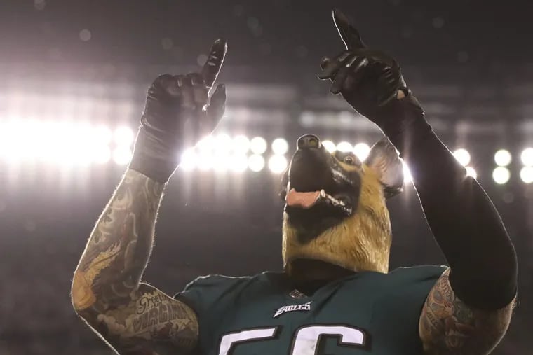 Eagles defensive end Chris Long wears a dog mask after the Eagles beat the Minnesota Vikings for the NFC crown on Sunday, Jan. 21, 2018.