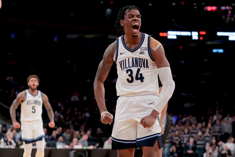 Brandon Slater (right) of Villanova celebrates after making a basket and getting fouled against Georgetown during the 2nd half of their Big East Tournament game at Madison Square Garden on March 8, 2023.  Justin Moore is left.