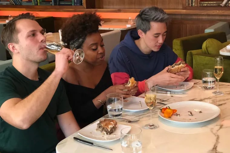 Andrew Ilnyckyj (left), Philly comedian Quinta Brunson, and Steven Lim taping an episode of the BuzzFeed series &quot;Worth It&quot; at Barclay Prime steakhouse.