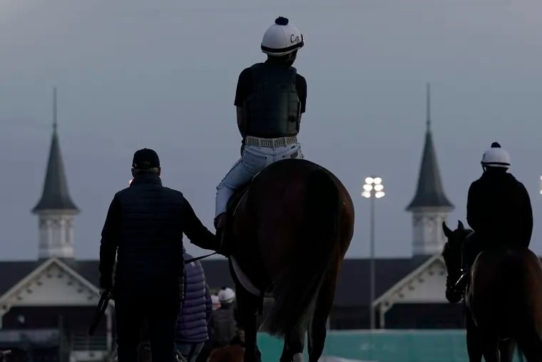 A horse is led onto the track for a workout at Churchill Downs.