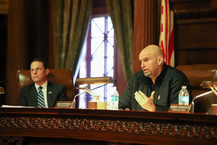 Pennsylvania Lt. Gov. John Fetterman, right, and state Attorney General Josh Shapiro, left, during a late 2019 Board of Pardons meeting in Harrisburg.