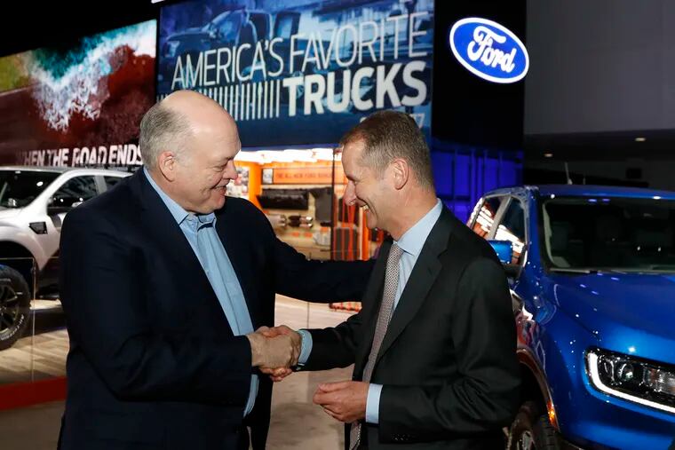 Ford Motor Co. president and CEO Jim Hackett (left) meets with Herbert Diess, CEO of Volkswagen AG, Monday, Jan. 14, 2019, at the North American International Auto Show in Detroit.