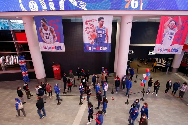 For the first time in more than a year, Sixers fans walk the Wells Fargo Center main concourse area before Sunday's game against the Spurs.