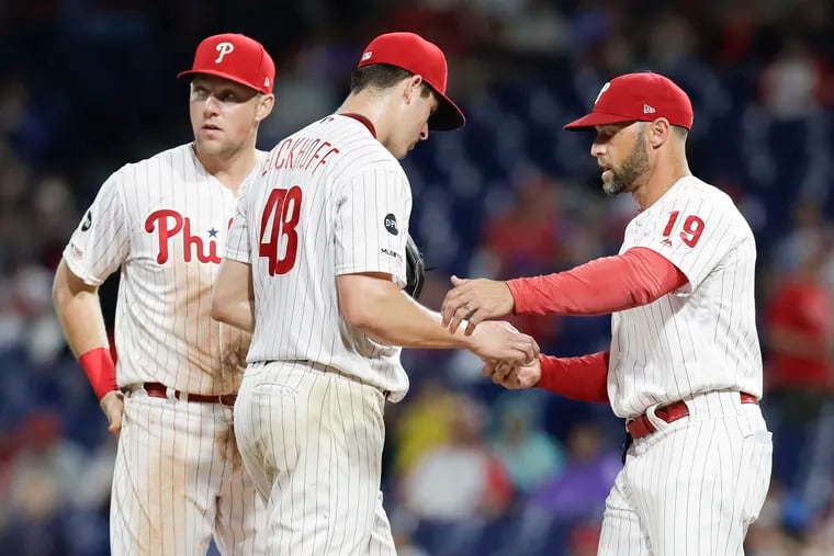 Phillies pitcher Jerad Eickhoff is replaced by manager Gabe Kapler with first baseman Rhys Hoskins looking on Monday night.