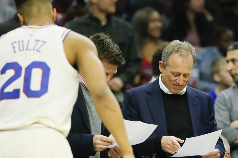 Sixers owner Josh Harris looks over Sixers team stats during a second-quarter break against the Milwaukee Bucks on Wednesday, April 11, 2018 in Philadelphia.