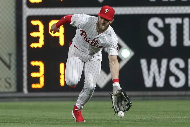 Phillies' Bryce Harper tries for Tigers' Nicholas Castellanos base hit during the 7th inning at Citizens Bank Park in Philadelphia, Wednesday, May 1, 2019
