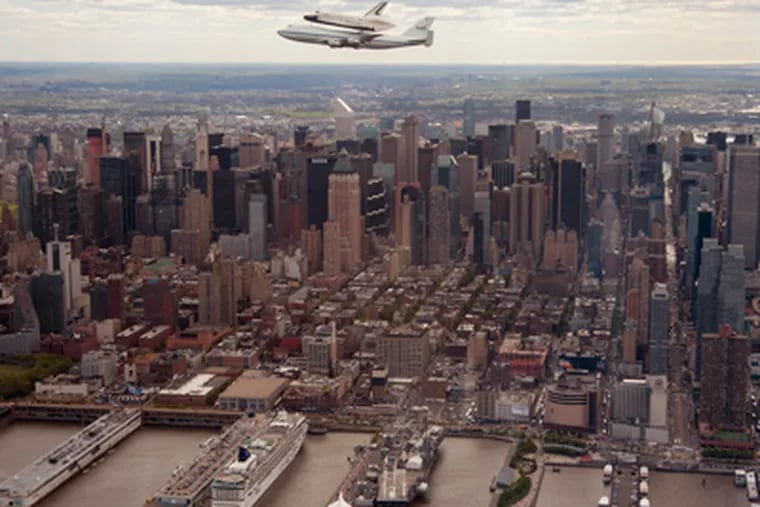 In this photo provided by NASA, Space shuttle Enterprise, riding on the back of the NASA 747 Shuttle Carrier Aircraft, flies over New York on Friday, April 27, 2012.  Enterprise is eventually going to make its new home in New York City at the Intrepid Sea, Air and Space Museum. ROBERT MARKOWITZ / NASA