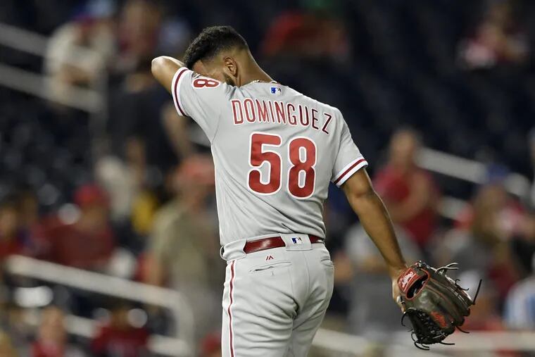 Seranthony Dominguez walks towards the dugout after he was pulled during the eighth inning of the Phillies' 8-6 loss to Nationals early Monday.