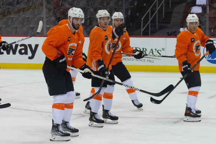 Derick Brassard, left, leads the way as he and his teammates converge on their goalie during the Philadelphia Flyers' morning skate ahead of their game against the New Jersey Devils on Wednesday, Dec. 8, 2021 in the Prudential Center. Brassard injured himself two weeks before, and this was his first practice back.