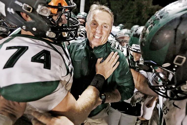 West Deptford's # 74 John Barrett hugs West Deptford HS football coach Clyde Folsom  after he got his 200th win with the Eagles after they won the West Deptford at Collingswood H.S. football game 34-7 on Oct. 23, 2015.