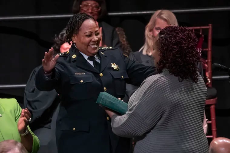 Newly sworn-in Philadelphia Sheriff Rochelle Bilal, left, prepares to hug a family member holding the Bible on which she took her oath of office on Jan. 6, 2020.