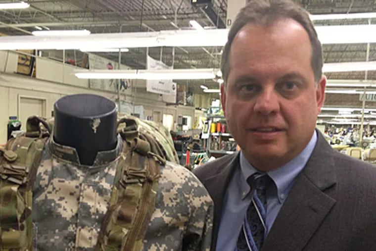 MICHAEL HINKELMAN / DAILY NEWS STAFF Robert L. Rosania of Ehmke with a three-day military pack made by his firm, founded in 1929 by former A's pitcher Howard Ehmke.