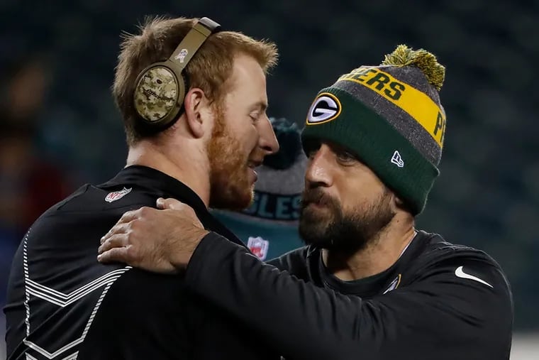 Carson Wentz (left) and Aaron Rodgers will battle once again.