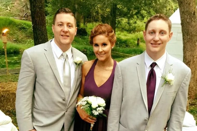 Christopher Hinkle (right) is seen in a recent family photo with his brother Eric and sister Danielle Calabro at Eric's wedding. He was fatally beaten inside a Philadelphia jail cell by a fellow inmate in April 2021. His family is now suing the city for wrongful death.