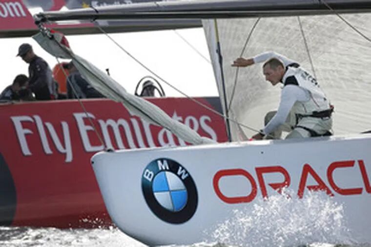 A bowman works the U.S. boat BMW Oracle in sailing against a New Zealand boat off Valencia, Spain. The American boat won.