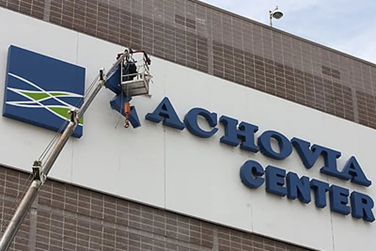 Workers begin removing the Wachovia Center logo. (Ed Hille/Staff Photographer)