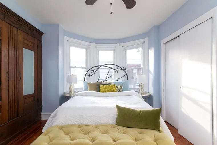 The master bedroom has a built-in armoire, part of the historic charm of the rowhouse.