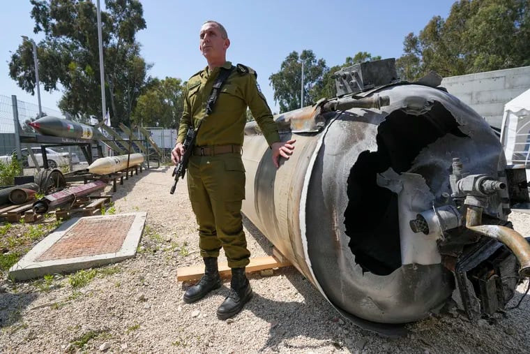 Israeli military spokesperson Rear Adm. Daniel Hagari displays to the media one of the Iranian ballistic missiles Israel intercepted over the weekend. Israel says Iran launched over 300 missiles and attack drones in the weekend attack. It says most of the incoming fire was intercepted, but a handful of missiles landed in Israel, causing minor damage and wounding a young girl.