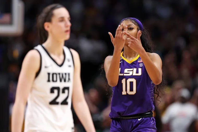 LSU's Angel Reese (10) gestures toward Caitlin Clark during the fourth quarter of Sunday's NCAA championship game.