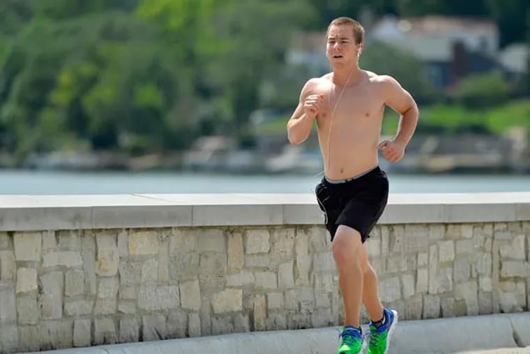 Jon Sestak runs laps on the dam at Lake Quivira in August 2013. While trying to stay competitive in sports, Sestak began to restrict his diet and exercise obsessively in high school, heading toward a diagnosis of anorexia in college. Today, he weighs a healthy 160 pounds. (Jill Toyoshiba/Kansas City Star/TNS)